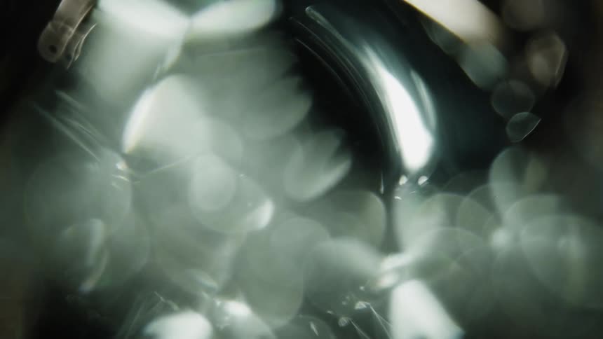 Light reflects off of the bubbles in the clear liquid