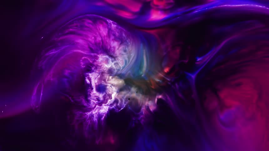 White light highlights the movement of an organic purple and pink substance as it expands in the darkness