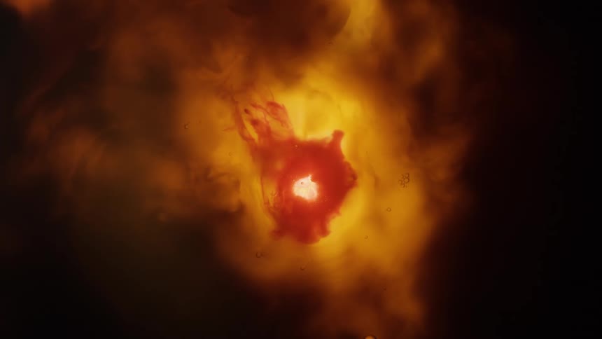 A hole closes up in the middle of a fiery red and orange blob