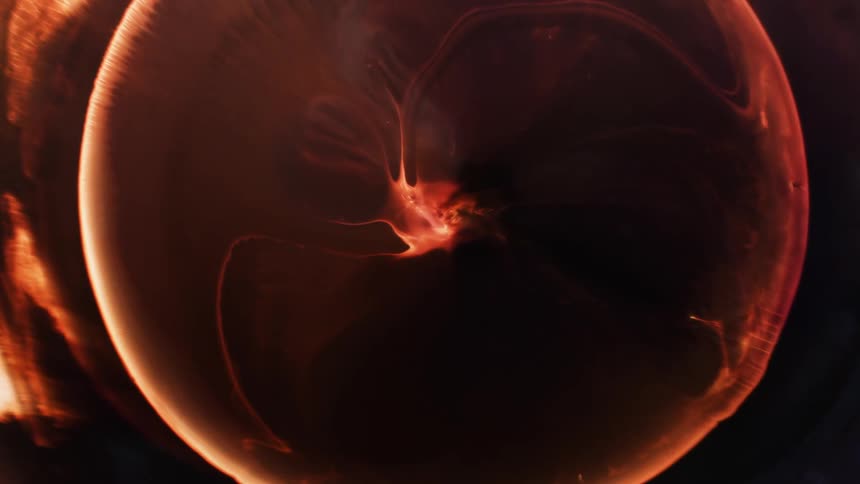 A bright orange circle glows at it grows as the inside moves to the edges