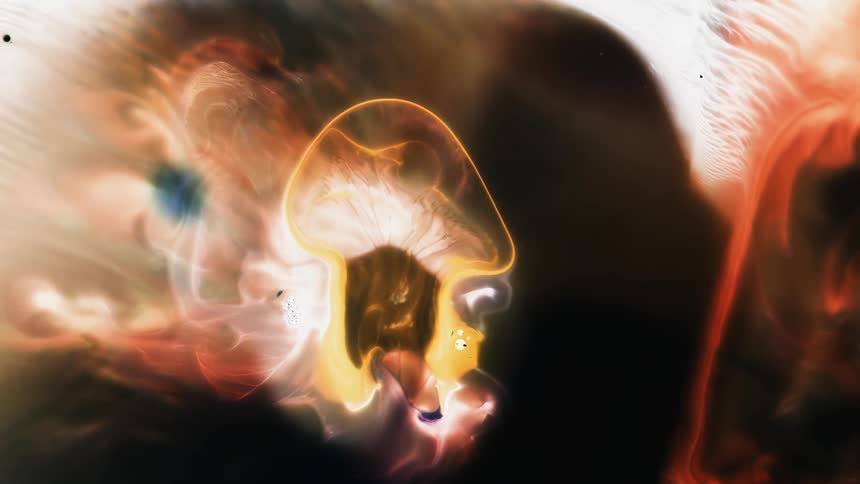 The outline of a liquidlike shape rapidly grows as it moves and spreads across the other colors