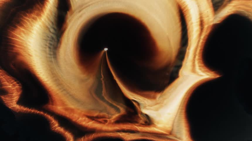 A stream of glowing orange light emerges from a light in the center and encompass the dark area with an organic texture