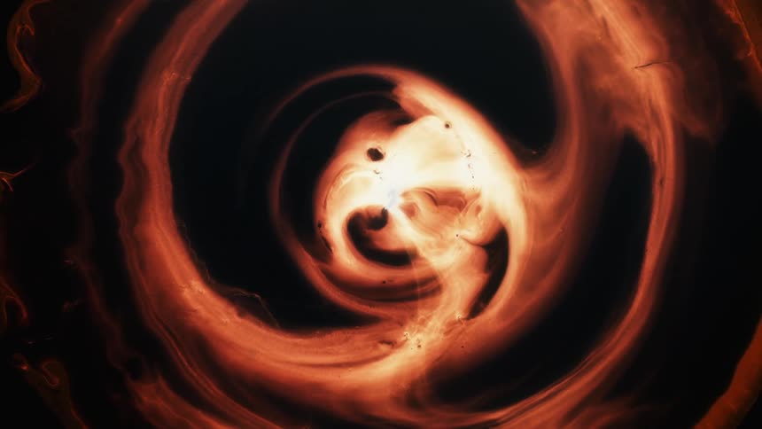 Visual effect of a moving cloud of dark ocher liquid ink flowing in slow waves