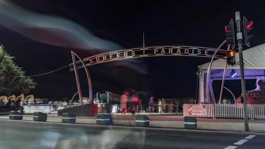 Time lapse view of people walking through a city at night