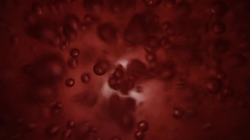 Abstract footage of light shining in liquid with bubbles