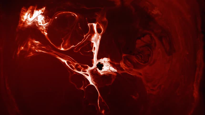 A bright white and redsubstance moves outward