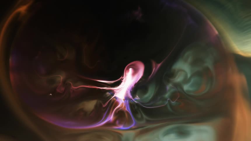 Colored liquid blends and swirls as it spreads