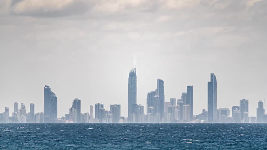 Water flows past a large city full of skyscrapers