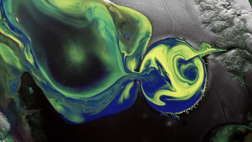 The green center of an organic amoeba is flowing among the blue and yellow into a circle that is being overcome by the amoeba