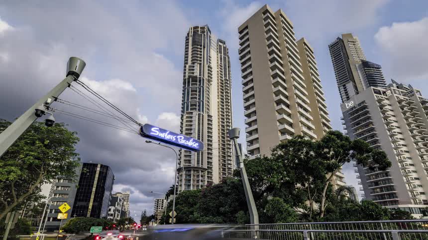 City skyscrapers next to highway with vehicles driving in the city