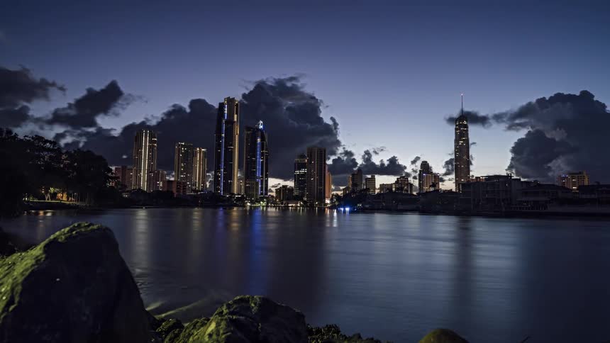 Clouds move over a city as it goes from night to daytime