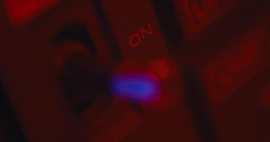 A person is flipping a switch in an electronic room