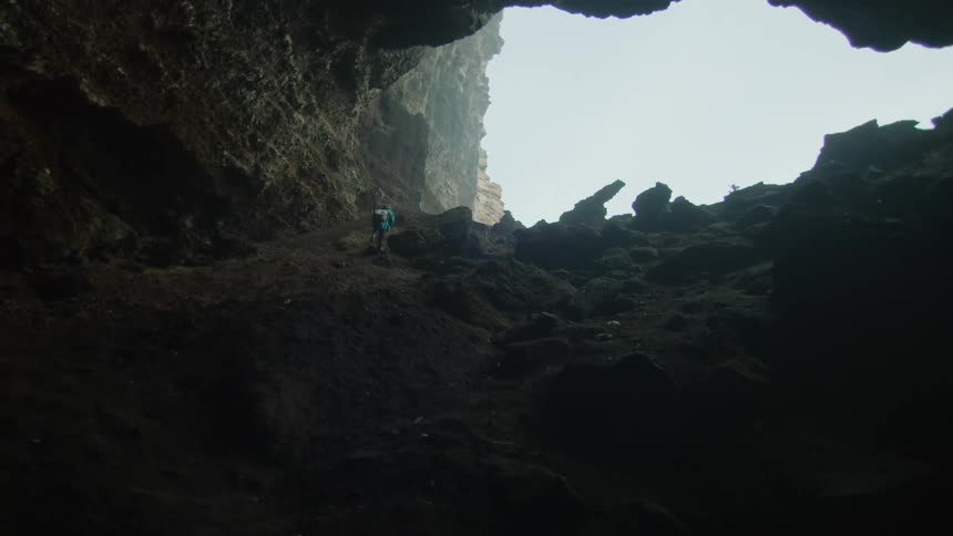 A person is hiking through a mountainous area