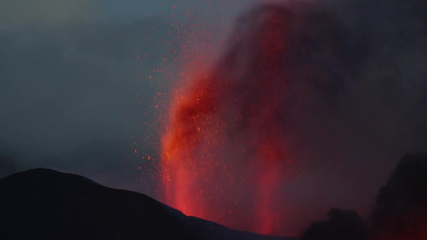 Footage of lava erupting is displayed