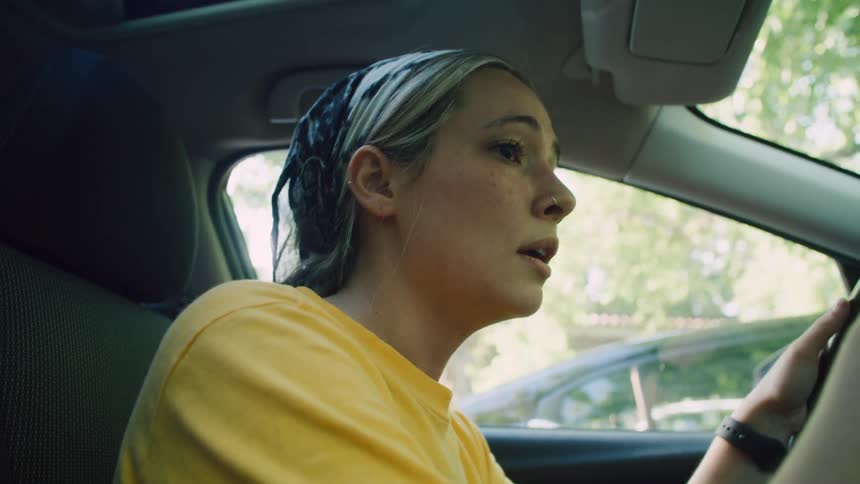 A woman is worried in the car