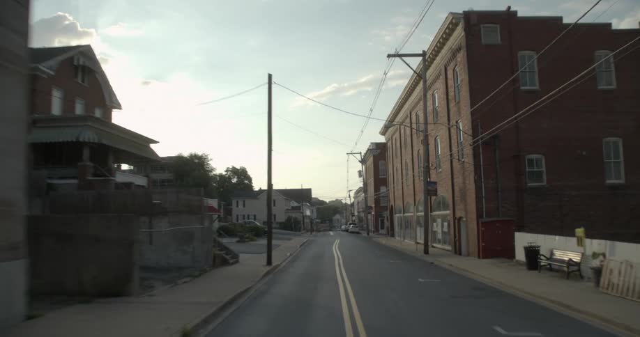 Small homes and brick buildings line the streets of a small town