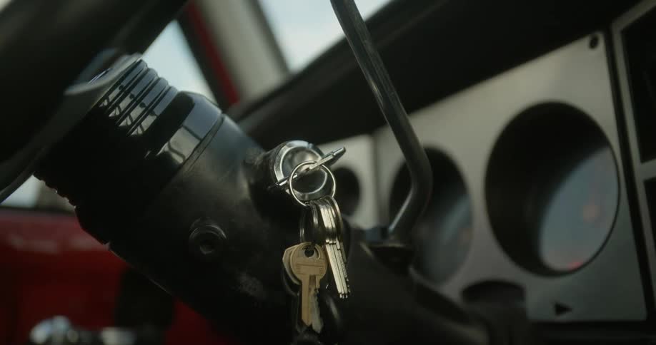 A person starts the car with a key