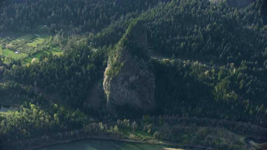 Beacon Rock rises high above the Columbia River in this slow reveal high altitude aerial shot