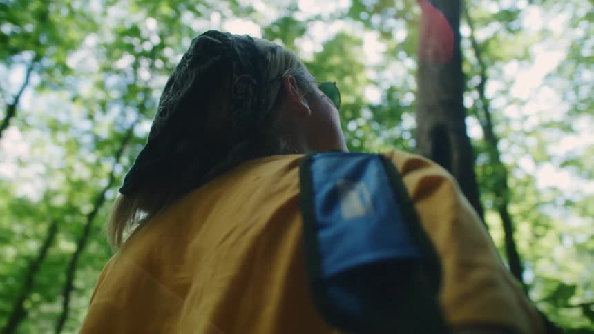 A woman is standing in the forest