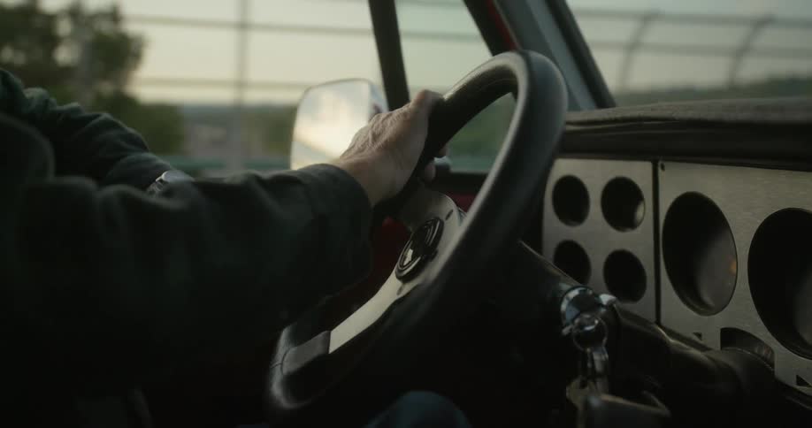 A man is driving near the fence