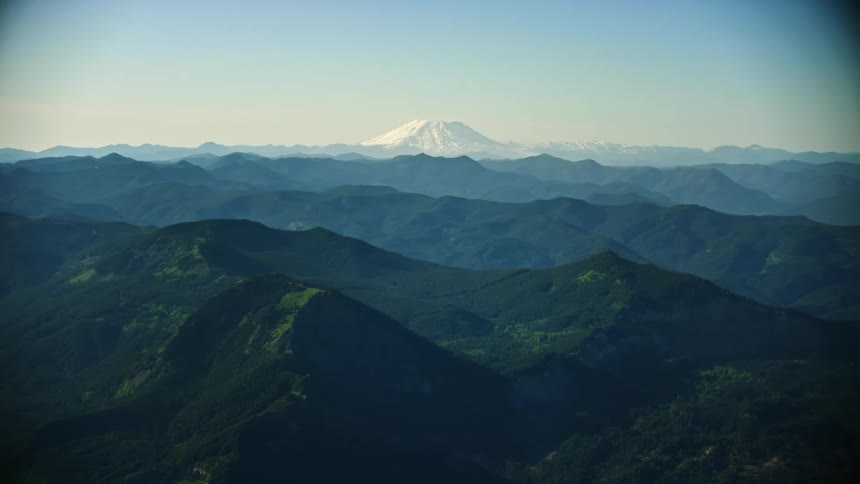 Awesome aerial shot of Mount Saint Helens and the Gifford Pinchot National Forest from high above the valley floor
