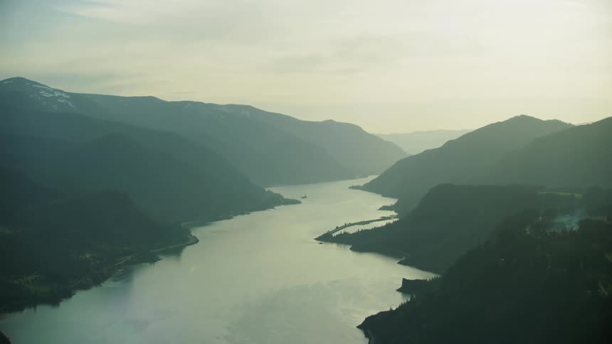A view of mountains and a river outside in the daytime