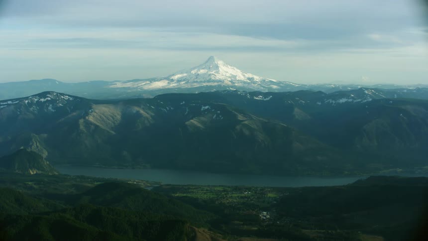 A view of a mountain in the distance covered in snow