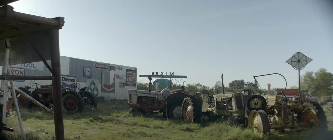 Farming equipment stored in a field close to the road