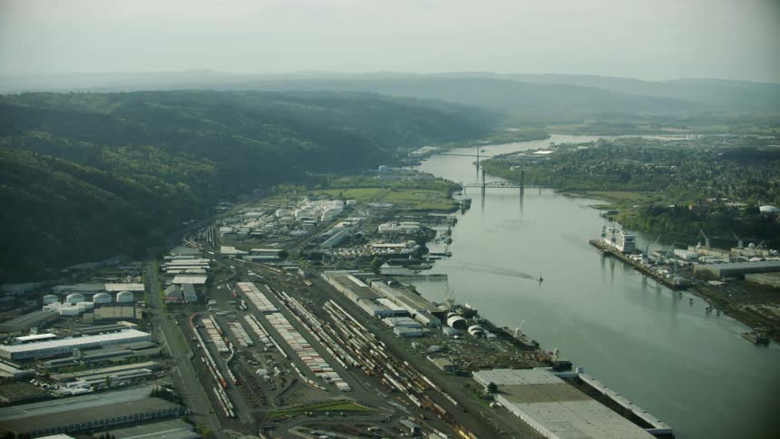 The Willamette River in downtown Portland with heavy rail and manufacturing industries doting the shoreline in late Spring as seen from the air