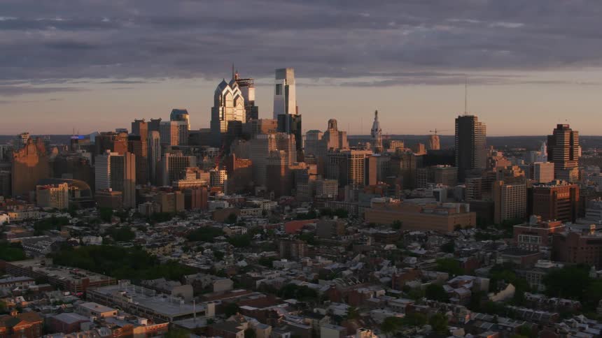 Downtown skyscrapers reflect sunlight as they stand against a red tinted sky