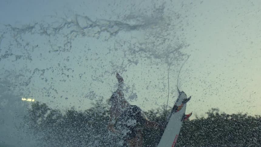 A male surfer jumping over an ocean wave