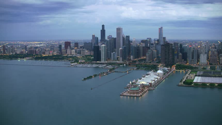 Large piers are in the river that flows through a very big city