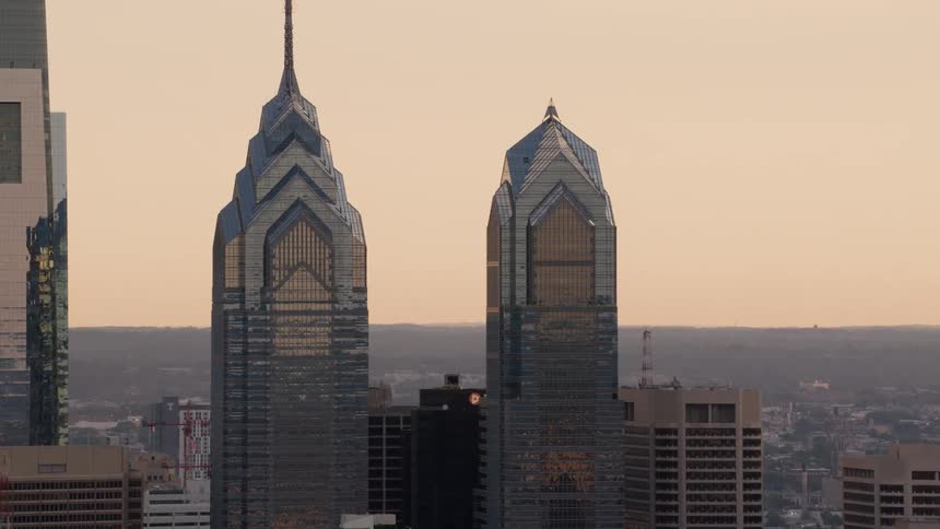 Haze hangs over a city with mirrored skyscrapers