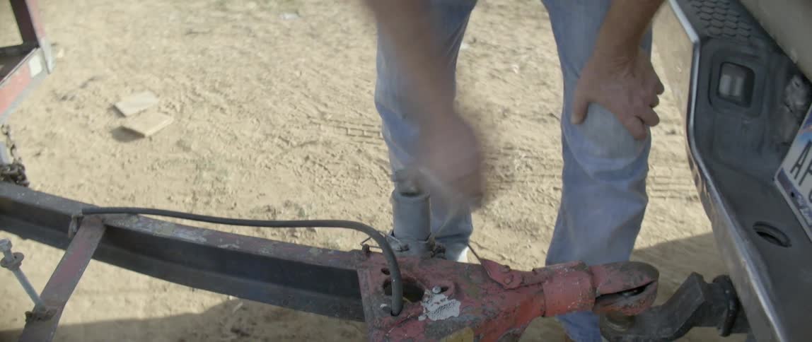 A person turns a crank