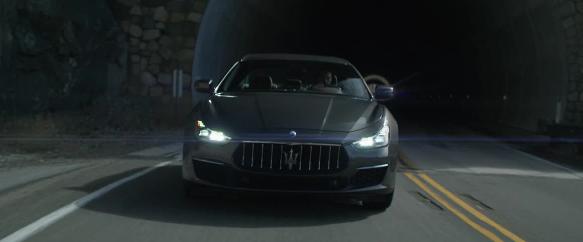 A man drives his car through a tunnel