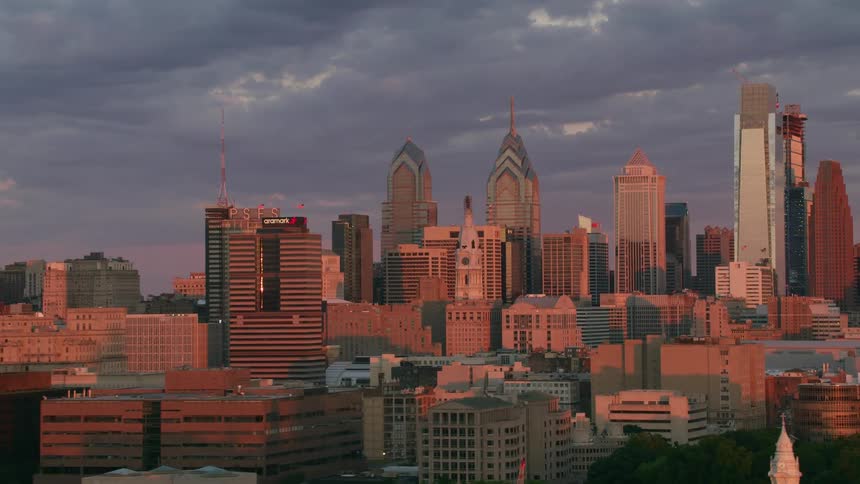 Aerial view of skyscrapers and buildings at sunset in the city