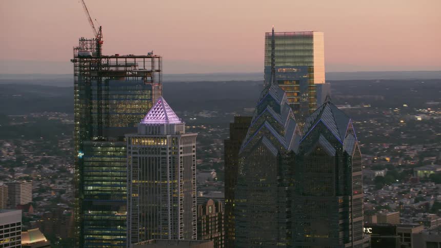 Aerial view of skyscrapers and towers in the city at dusk