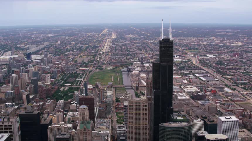 An aerial view of skyscrapers in a coastal city in the morning