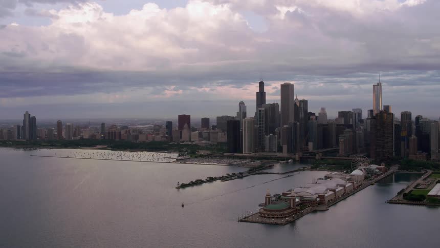 An aerial view of a pier and skyscrapers in a coastal city