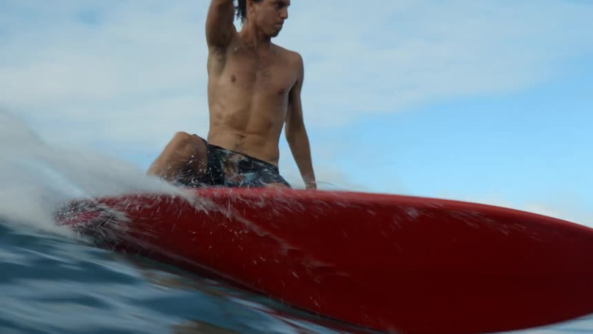 A surfer is riding a big wave and then the view goes underwater