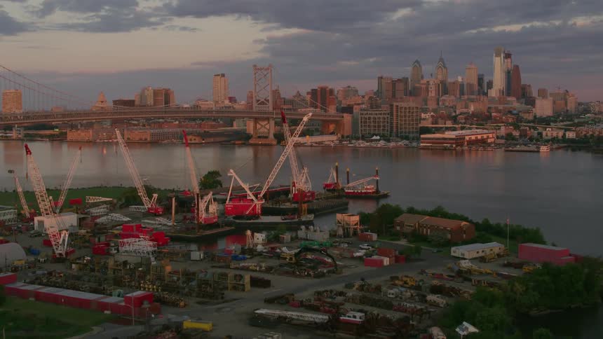 Cranes are near the bridge by the city