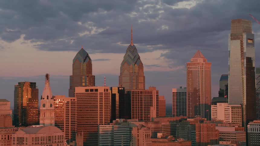 Buildings and skyscrapers in the city sit under the cloudy sky