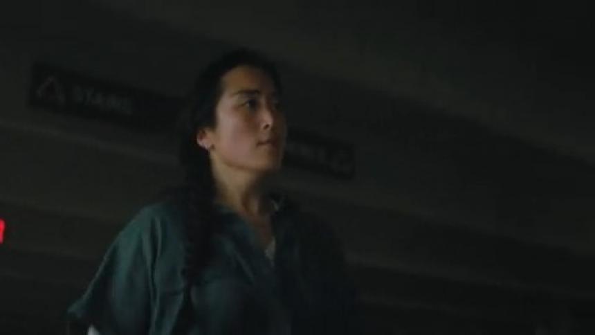 A woman walks through the parking garage upset