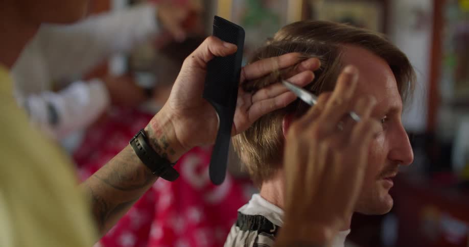 A man is getting a haircut in a hair salon