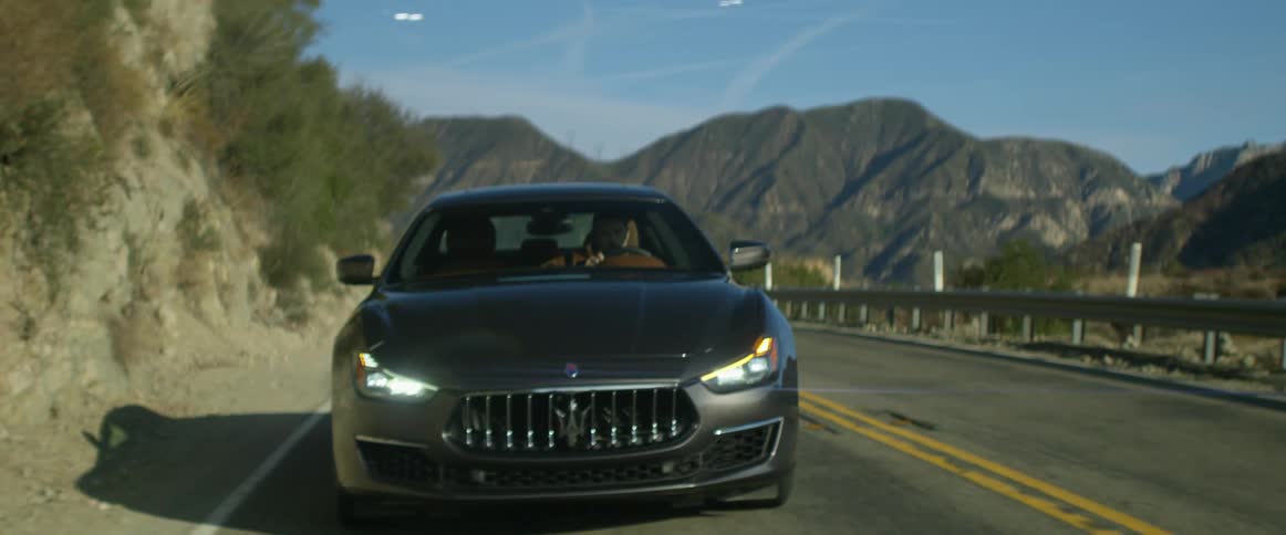 A man is driving a car on the highway