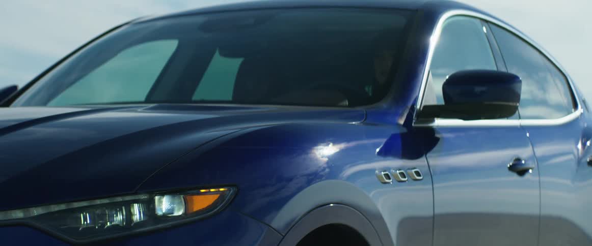A woman driving an suv on a dirt road