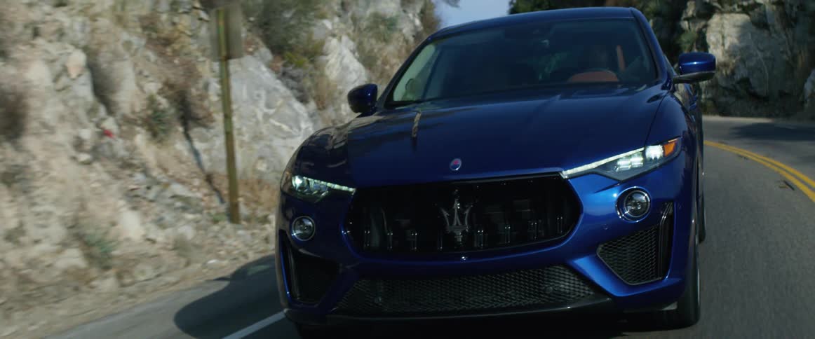 A person is driving a car through the mountains