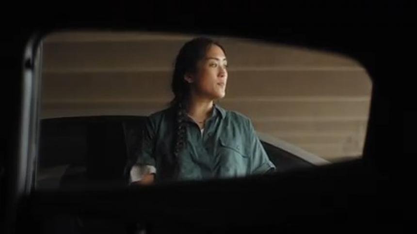 A woman looks disappointed after being ignored by another person in a parking garage