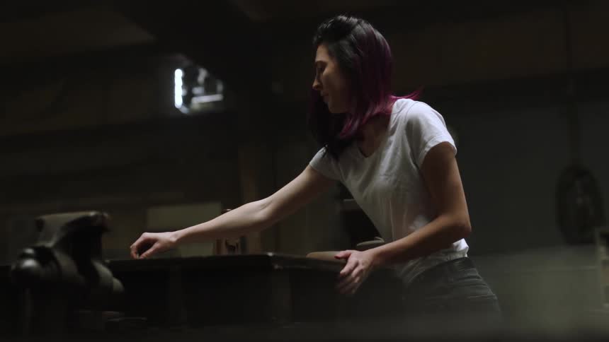 A woman stands while working in a cellar studio