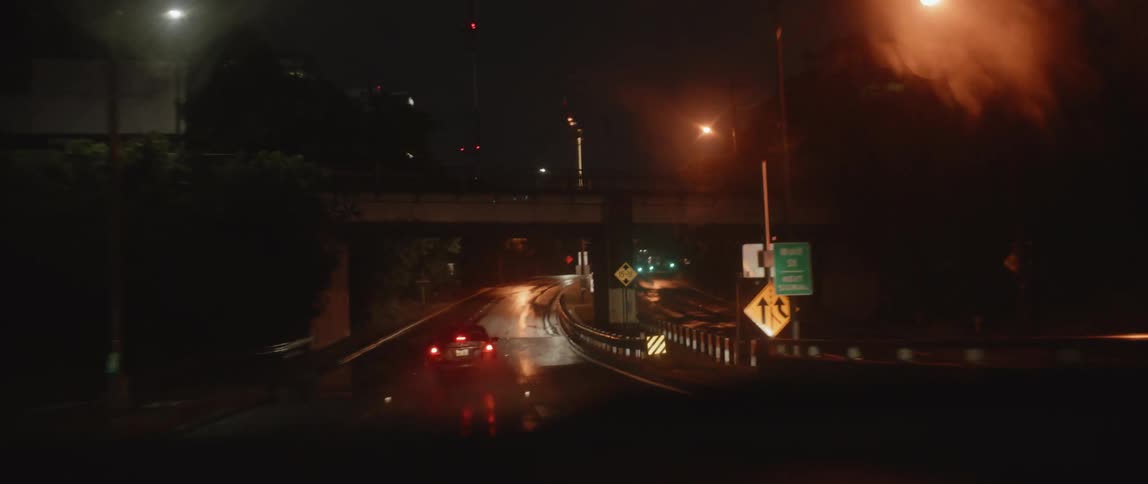 A car driving behind another car at night
